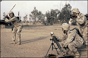 Photo of three troops playing ball.