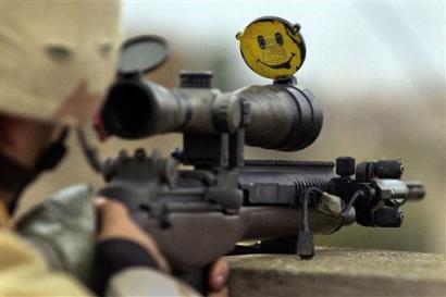 AP News photo of sniper rifle scope with smiley decal